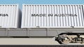 Cargo train and containers with MADE IN AUSTRIA caption. Railway transportation. 3D rendering Royalty Free Stock Photo