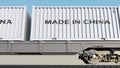 Cargo train and containers with MADE IN CHINA caption. Railway transportation. 3D rendering