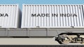 Cargo train and containers with MADE IN INDIA caption. Railway transportation. 3D rendering