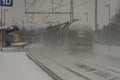 Cargo train near Veseli nad Luznici stop with snowy platforms and cloudy sky