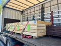 Cargo transportation of screws in wooden and metal boxes in a semi-trailer truck. Side loading of bolts