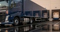 Cargo truck parked in loading dock area, showcasing sleek design and reflective surface, ready for logistics operations and Royalty Free Stock Photo