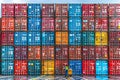 Cargo truck at port dock with workers unloading colorful containers from container ship Royalty Free Stock Photo