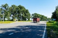 A cargo van on a country highway. Logistics, delivery of goods, road transport - a truck moves on an asphalt road on a summer day Royalty Free Stock Photo