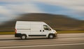 Cargo van is driving on the highway at speed with a blurred background Royalty Free Stock Photo