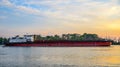 Big ship on the Danube river, big industrial vessel at the border with Ukraine a sunset