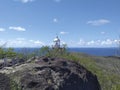 Caribbean coast landscape with lighthouse tower under blue sky with tropical clouds. Tropical coastal vegetation background Royalty Free Stock Photo