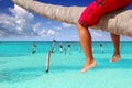 Caribbean inclined palm tree beach tourist legs