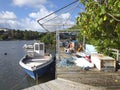 Caribbean pier with fishing boat moored. Tropical landscape. Blue sky with white tropical clouds Royalty Free Stock Photo