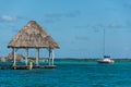 Caribbean scene with hut and Sailboat. Bacalar, near tulum. Trav Royalty Free Stock Photo