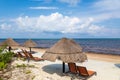 Caribbean Sea with Beach chairs and grass umbrellas in Cancun Royalty Free Stock Photo