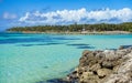 Caribbean Sea with Green Palms, Blue Cloudy Sky and Rocky Coast. Travel Destination for Holidays