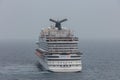 The Caribbean Sea - May 26, 2020: Aerial cloe-up shot of Carnival Vista anchored at sea in the fog. Grey foggy sky in the