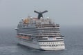 The Caribbean Sea - May 26, 2020: Aerial cloe-up shot of Carnival Vista anchored at sea in the fog. Grey foggy sky in the