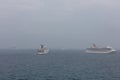 The Caribbean Sea - May 26, 2020: Aerial shot of Carnival Elation, Carnival Sunrise anchored at sea in the foreground. Carnival