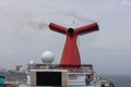 The Caribbean Sea - May 26, 2020: Funnel and main open deck screen of Carnival Valor anchored at sea in the fog. Grey foggy sky