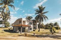 Caribbean themed cottages with back patios, white walkway. Small white country house for recreation