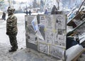 Caricatures on Vladimir Putin and Victor Yanukovich set on stand on the street, caricature artist standing near Royalty Free Stock Photo