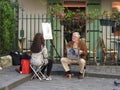 Caricaturist at work, Place du Tertre, Montmartre, Paris.