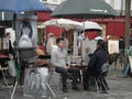 Caricaturist at work, Place du Tertre, Montmartre, Paris.