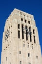 Carillon bell tower with clock against blue sky