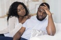 Young african woman comforting her upset boyfriend Royalty Free Stock Photo