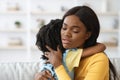 Caring African American Woman Hugging Little Daughter, Comforting Her Upset Child Royalty Free Stock Photo