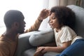 Caring african father touching forehead of ill kid daughter Royalty Free Stock Photo