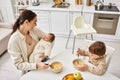 caring beautiful mother having breakfast with