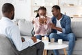 Caring Black Husband Comforting Crying Wife During Therapy Session At Councelor`s Office