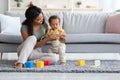 Caring Black Mom And Adorable Infant Son Playing With Toys At Home Royalty Free Stock Photo