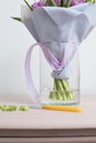 Caring for a bouquet of flowers, step by step. Cut the stems and put in a vase. Young woman holding a beautiful bunch of Royalty Free Stock Photo