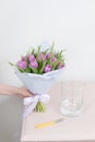 Caring for a bouquet of flowers, step by step. Cut the stems and put in a vase. Young woman holding a beautiful bunch of Royalty Free Stock Photo