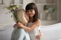 Caring little granddaughter greeting senior granny with anniversary Royalty Free Stock Photo