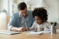 Caring dad help biracial daughter with homework at home Royalty Free Stock Photo