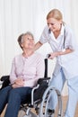 Caring doctor helping handicapped patient