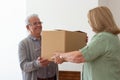 Caring elderly couple moving into new house