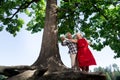 Caring elderly husband taking his beautiful wife for a walk in park