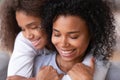Caring family single mom and african teen daughter embracing cuddling Royalty Free Stock Photo
