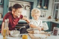 Caring father assisting his son rolling out pastry for pie