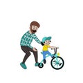 A caring father teaches his daughter to ride a bike for the first time. Father helps little boy child riding a bike