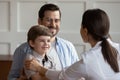 Caring female doctor cheer small boy patient Royalty Free Stock Photo