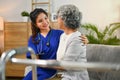 Caring female doctor visiting senior woman patient at home. Elderly health care concept