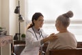 Caring female nurse examine senior woman patient