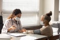 Female nurse measure blood pressure of mature patient Royalty Free Stock Photo