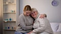 Caring girl hugging disabled grandmother, supportive relationships in family