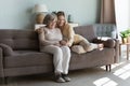 Caring granddaughter hugs grandmother spend leisure use modern smartphone Royalty Free Stock Photo