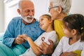 Caring granddaughters hugging grandfather supporting him after medical surgery in hospital ward Royalty Free Stock Photo