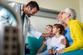 Caring granddaughters hugging grandfather supporting him after medical surgery in hospital ward Royalty Free Stock Photo