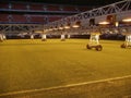 Caring for grass lawn. Lighting installation on soccer stadium Royalty Free Stock Photo